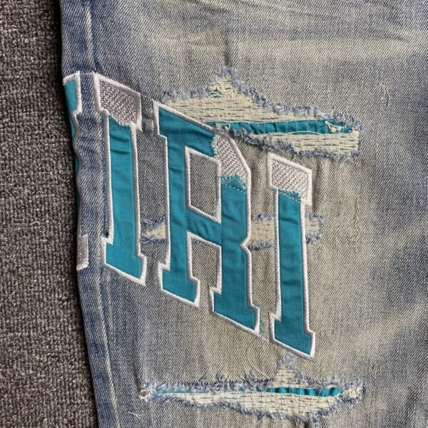 AMIRI VARSITY LOGO JEANS